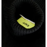 En sort ribstrikket rullekrave sweater viser etiketmærket med teksten "JJXX" inde i halsudskæringen.