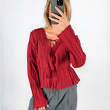 Modelfoto af pige i rød BREA bluse og grå LISA bukser. Alt er fra BySofieSønderby.