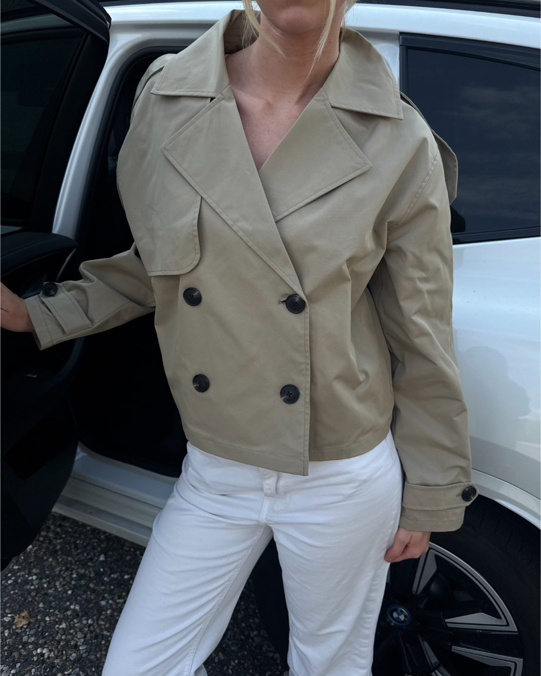 Modelfoto af pige der bærer Carlie jakke i beige, samt hvid bukser. Alt fra BySofieSønderby