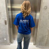 Stemningsbillede af pige der bærer en kongeblå t-shirt med hvidt classic tryk og blå NANNA jeans.  Fra BySofieSønderby