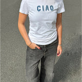 Modelfoto af pige i hvid t-shirt med Ciao syet på brystet, samt grå Palermo jeans. Alt er fra BySofieSønderby