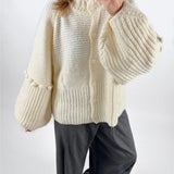 Modelfoto af pige med creme farvet RUTHIE strik cardigan, samt grå MILAN bukser. Set forfra. Alt er fra BySofieSønderby