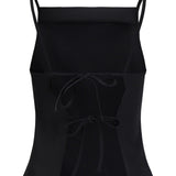 Sort crop top med tynde stropper og to bindebånd foran, placeret mod en hvid baggrund.