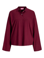 En mørkerød langærmet poloshirt hænger mod en hvid baggrund. Skjorten har en krave og tre knapper. Mærket viser "BRYX" i pink tekst.